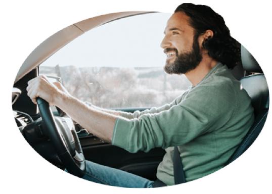 A man shows his good driver skills by checking his rearview mirror.