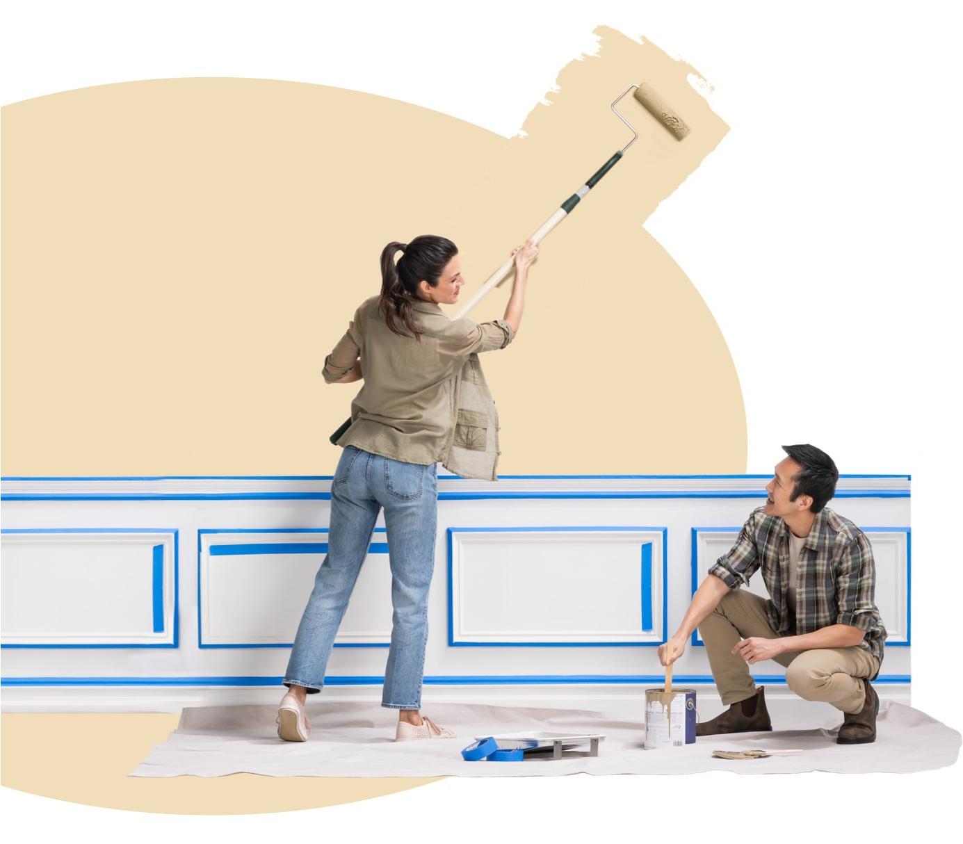 Woman paints outside the khaki oval with an extended roller as her husband takes on the wall moulding.